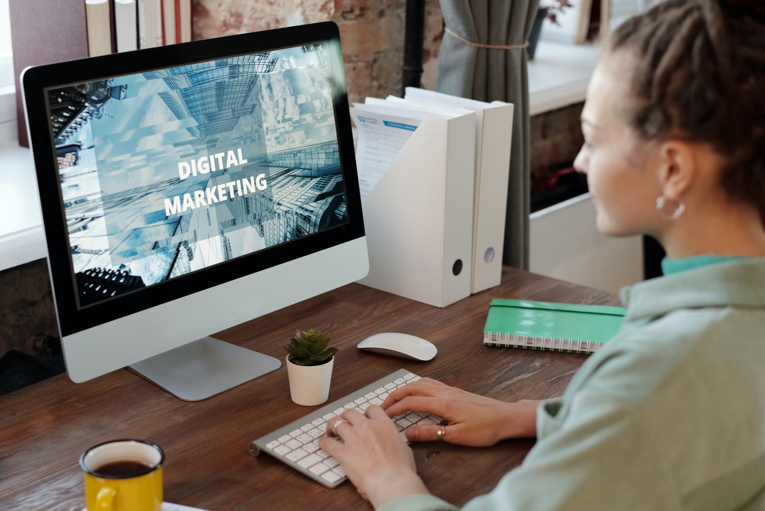 Woman working at a desktop with Digital Marketing text on screen